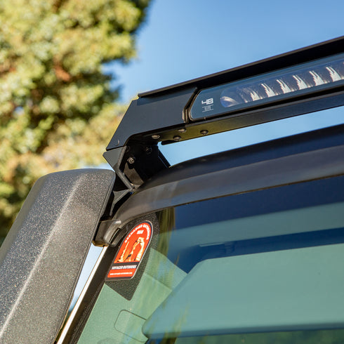 Low Profile Lite bar with a cutout for a snorkel on an Ineos Grenadier with a clear blue sky background