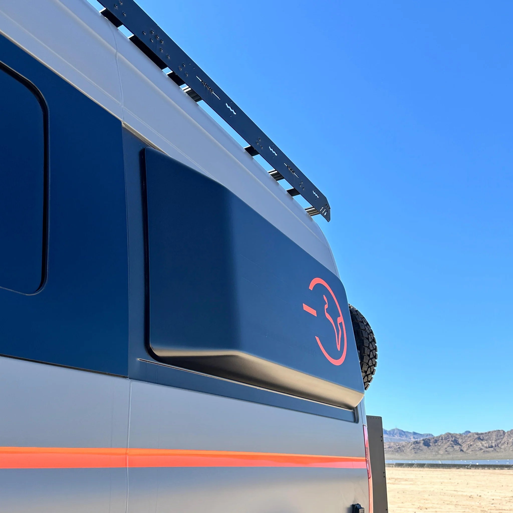 Fully insulated GRP window flares for a Mercedes Sprinter van, designed to create a 77-inch wide interior sleeping area.