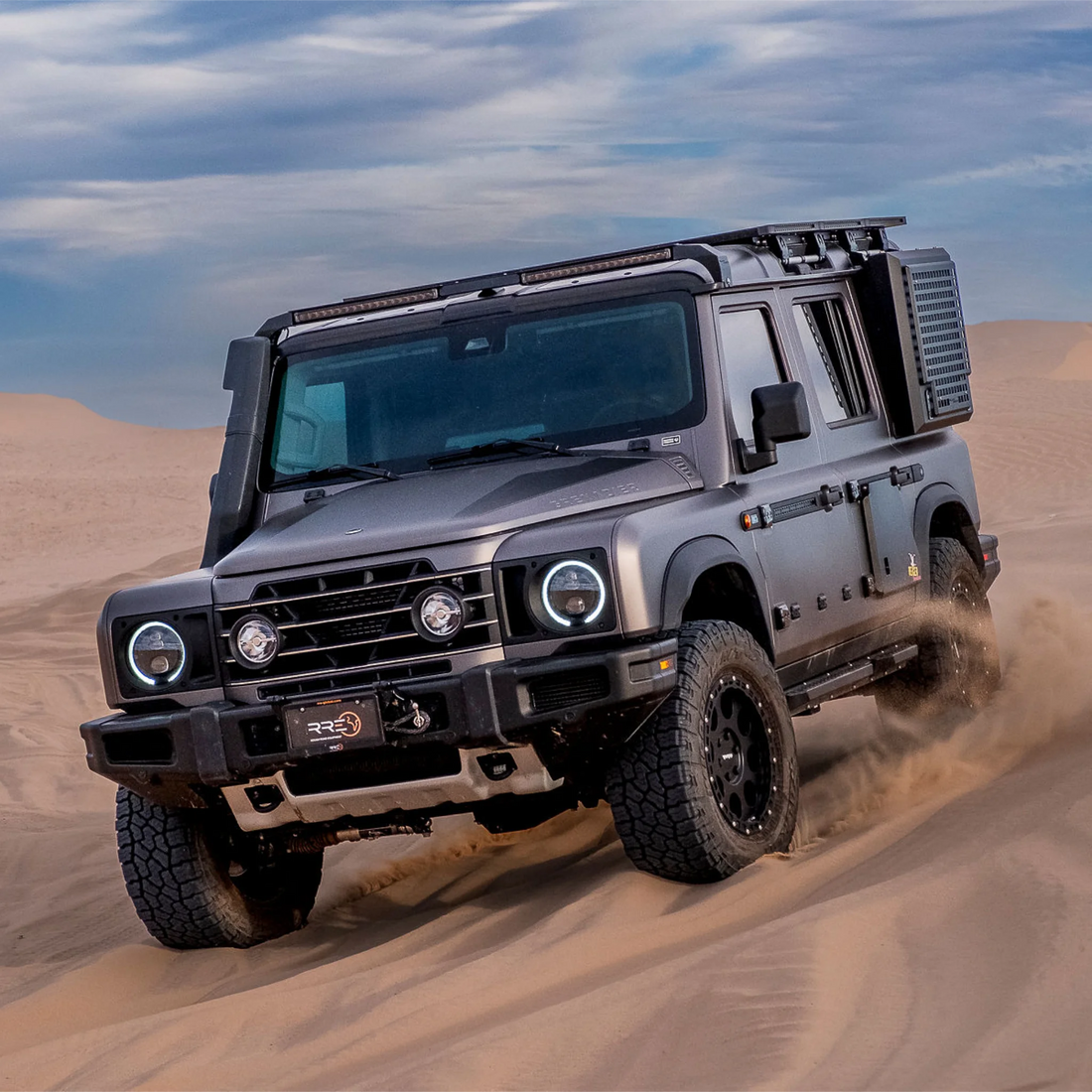 Ineos Grenadier driving through desert sand dunes