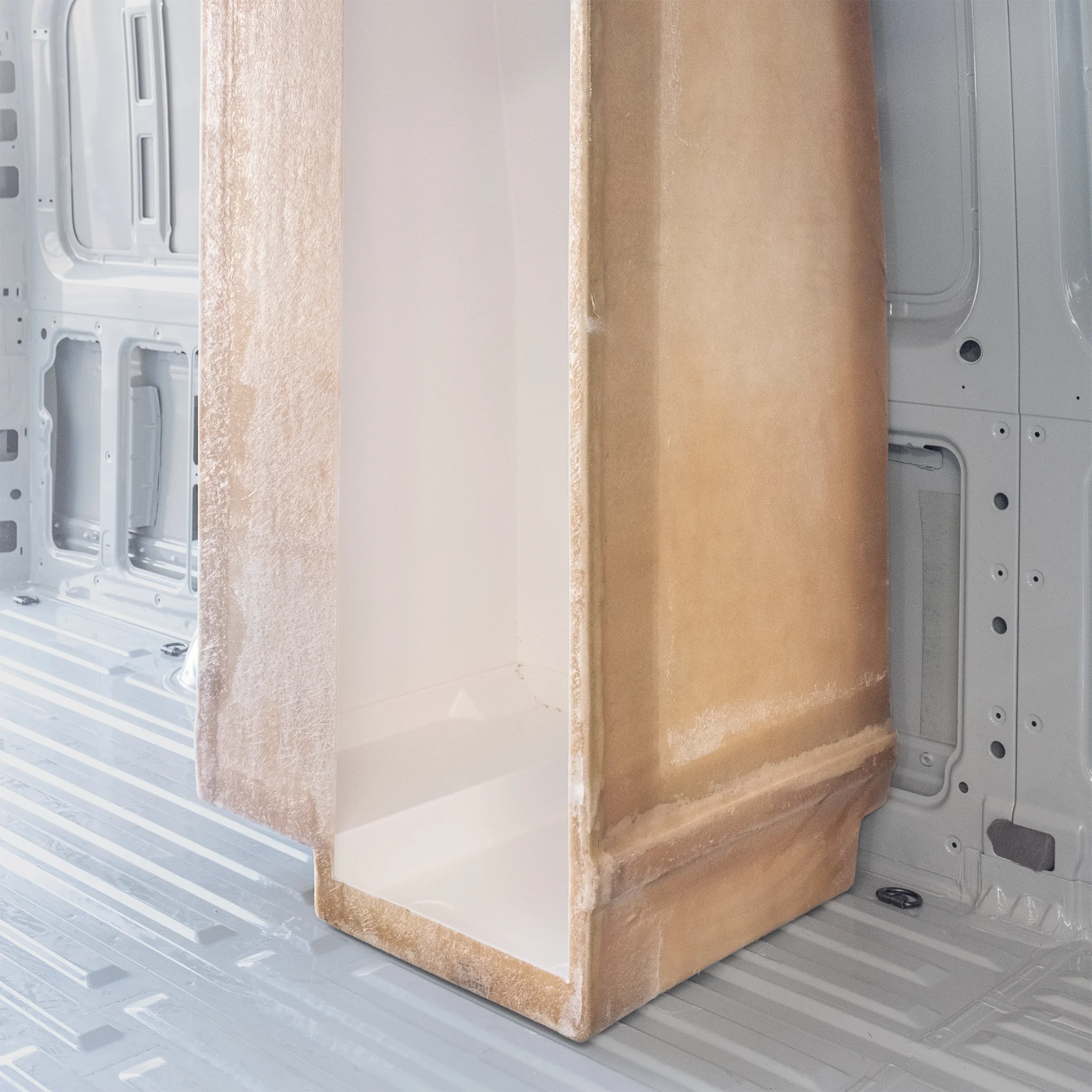 High-quality FRP camper van shower booth with a gel-coat finish, contoured to fit the interior wall of a Mercedes Sprinter or Ford Transit.