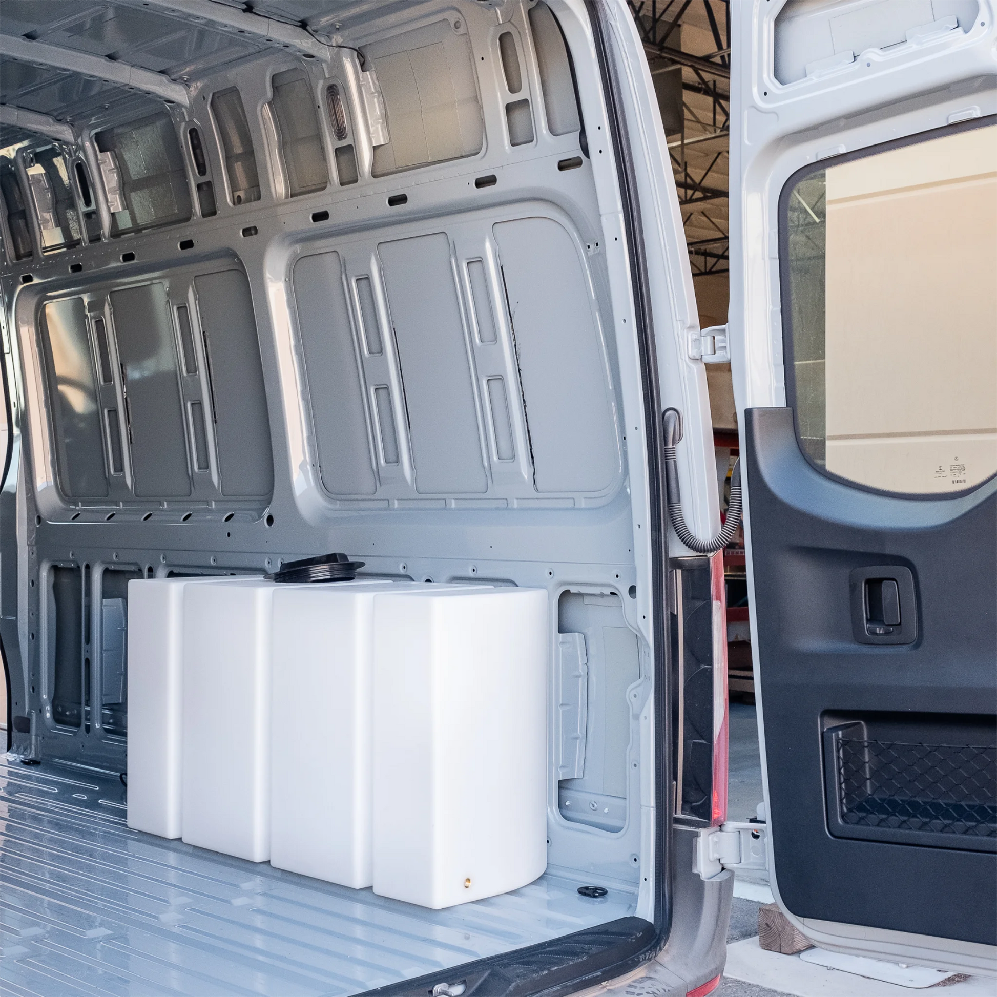 Heavy-duty 59.4 gallon poly wheel well fresh water tank with brass fittings, contoured for Mercedes Sprinter 144 and 170 wheelbase.